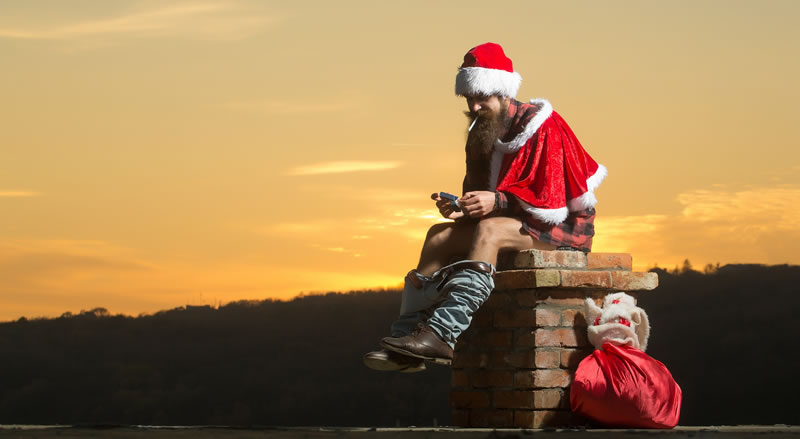 Bad santa sitting on chimney