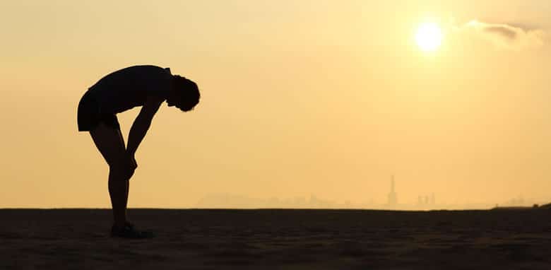 Exhausted sportsman at sunset